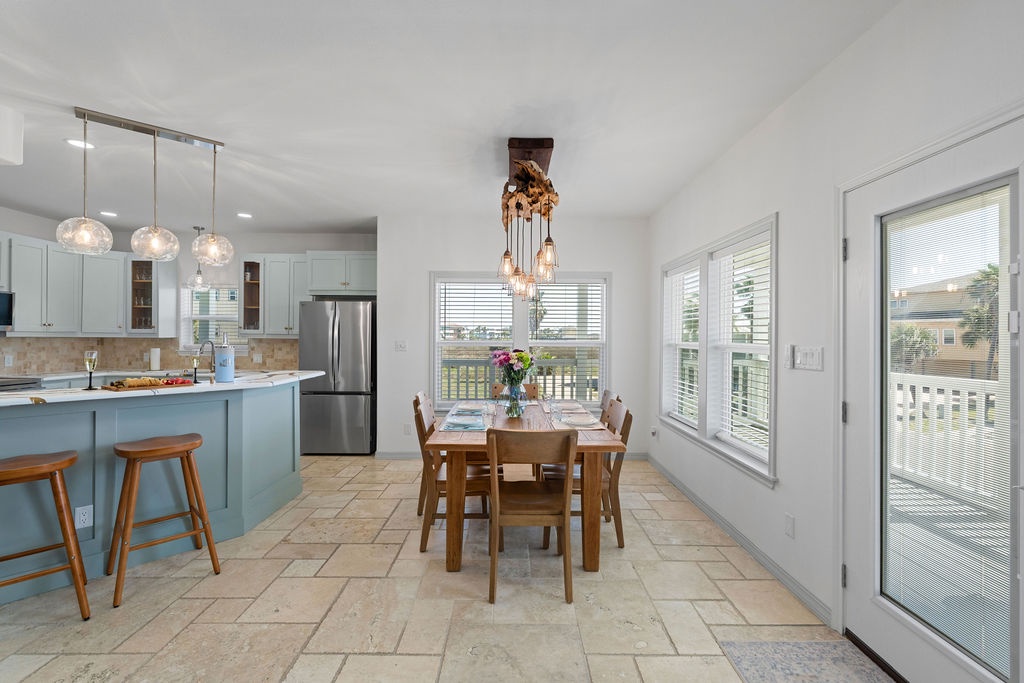 Your open-concept kitchen and dining space features modern appliances, a stylish island, and warm wood accents that create the perfect gathering spot.