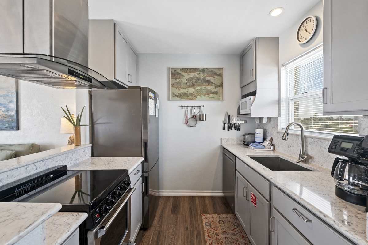 Your fully equipped galley kitchen features stainless appliances, marble countertops, and everything needed to prepare memorable meals during your stay.
