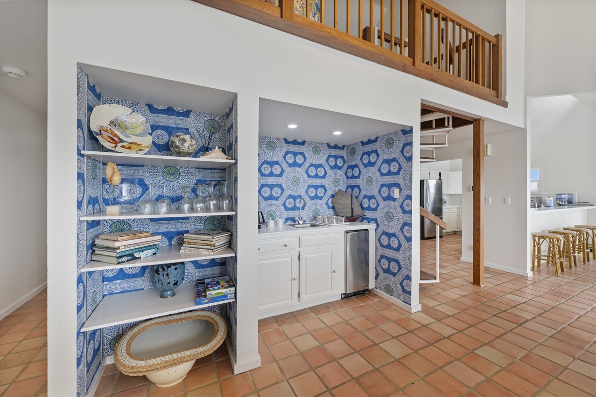 Your open-concept kitchen features stunning blue patterned tiles, modern appliances, and clever built-in storage for all your vacation essentials.