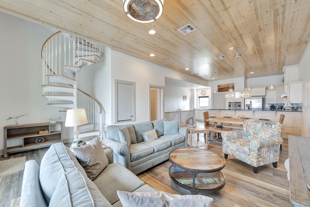 Unwind in your stylish coastal living space with soaring wood ceilings, comfortable seating, and an open layout perfect for gathering.