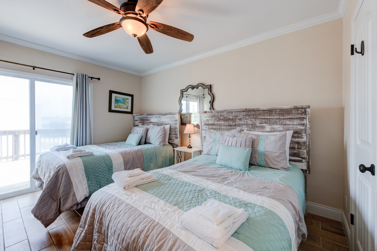 Wake up refreshed in your coastal bedroom with comfortable twin beds, rustic charm, and ocean views just steps away.