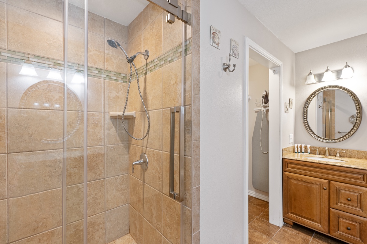 Refresh in your elegant stone-tiled shower with rainfall showerhead, then pamper yourself at the granite vanity with perfect lighting.