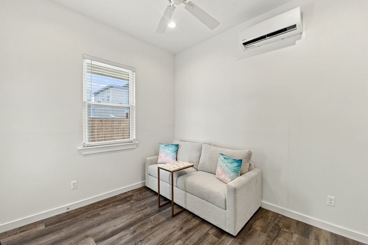 Sink into the plush sleeper sofa and unwind with a ceiling fan overhead and coastal-inspired touches - this cozy corner is perfect for reading or relaxing.