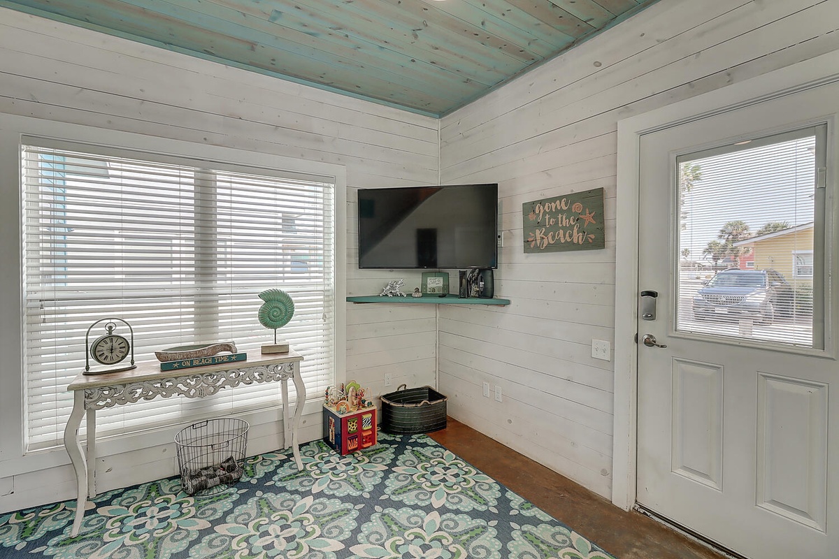 Settle into your charming coastal living space with warm wood-planked walls, beachy décor, and a peaceful atmosphere perfect for unwinding after beach days.
