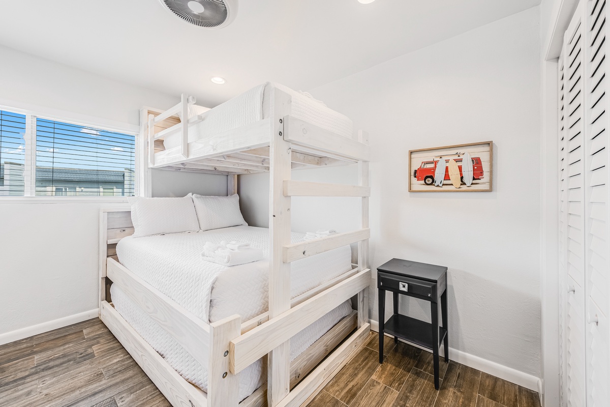 Your kids will love this bright bedroom with sturdy white bunk beds, perfect for siblings or friends sharing adventures together.