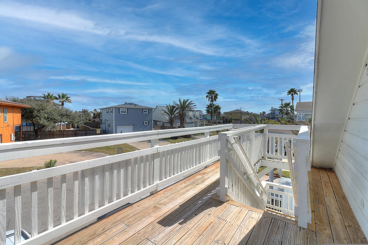 Step out onto your private deck and breathe in the coastal breeze while taking in the charming neighborhood views below.