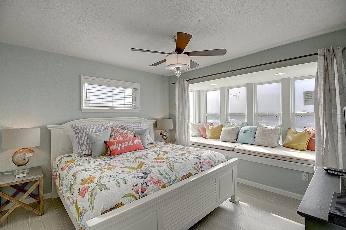 Wake up to stunning ocean views from your cozy bedroom, complete with a built-in window seat where you can enjoy morning coffee.