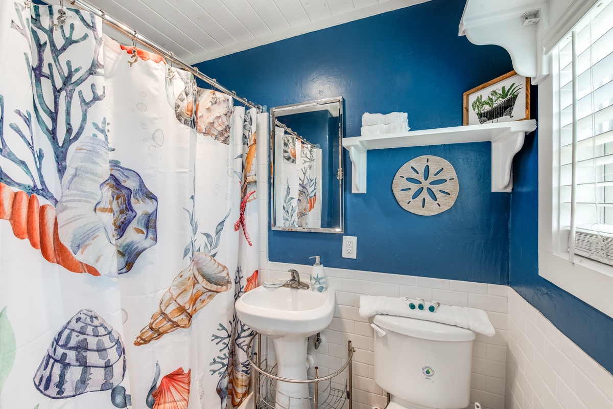Step into your coastal-themed bathroom with vibrant ocean-inspired decor and nautical touches that make every morning feel refreshing.