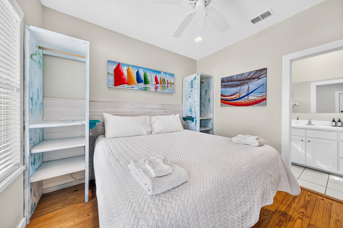 Sink into crisp linens and let coastal charm wrap around you—your bedroom features thoughtful storage, gentle ceiling fan breezes, and a private en-suite for effortless mornings.