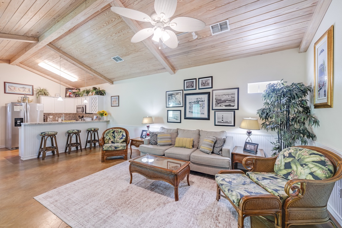 Relax in your bright, open living space with vaulted wood ceilings and tropical touches that create the perfect coastal retreat atmosphere.