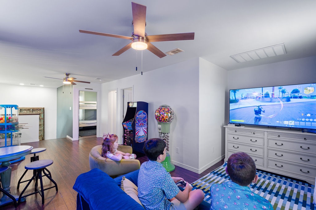 Unwind in your spacious game room featuring arcade fun, cozy seating, and big-screen entertainment for memorable family moments.