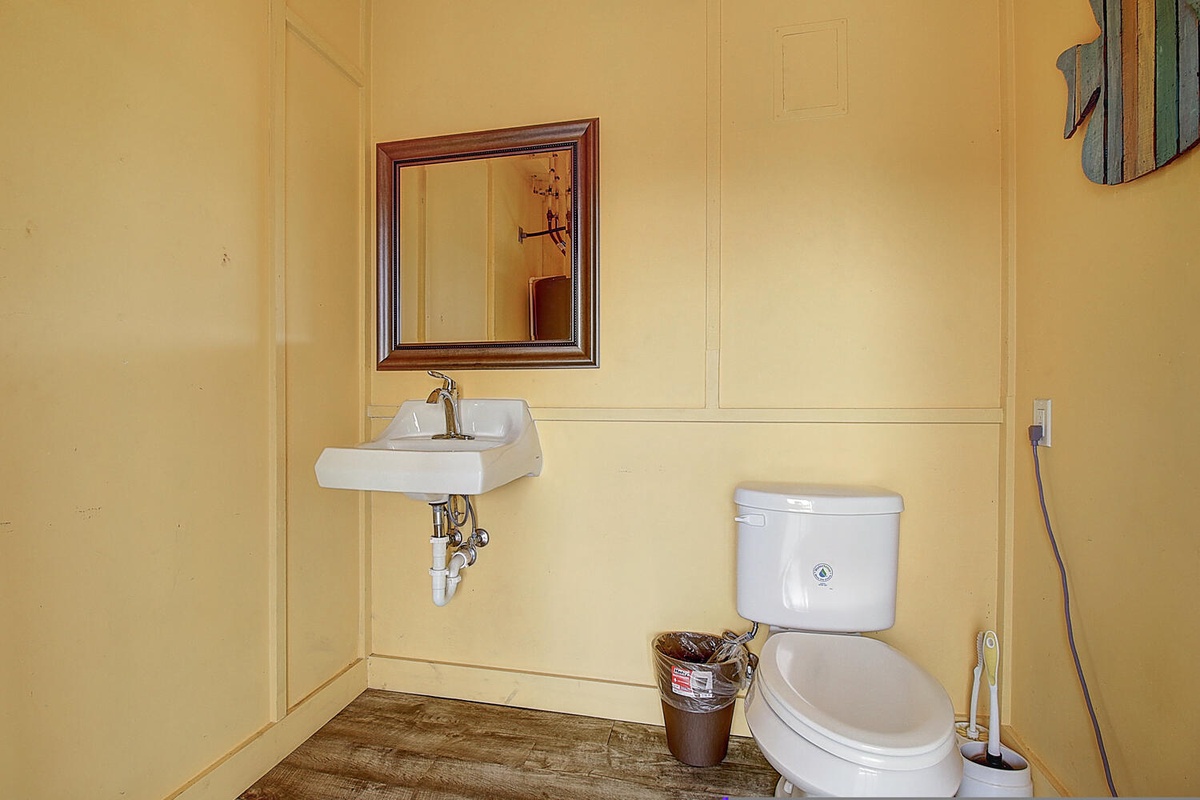 Your private powder room features a charming wall-mounted sink and classic details that add character to your stay.