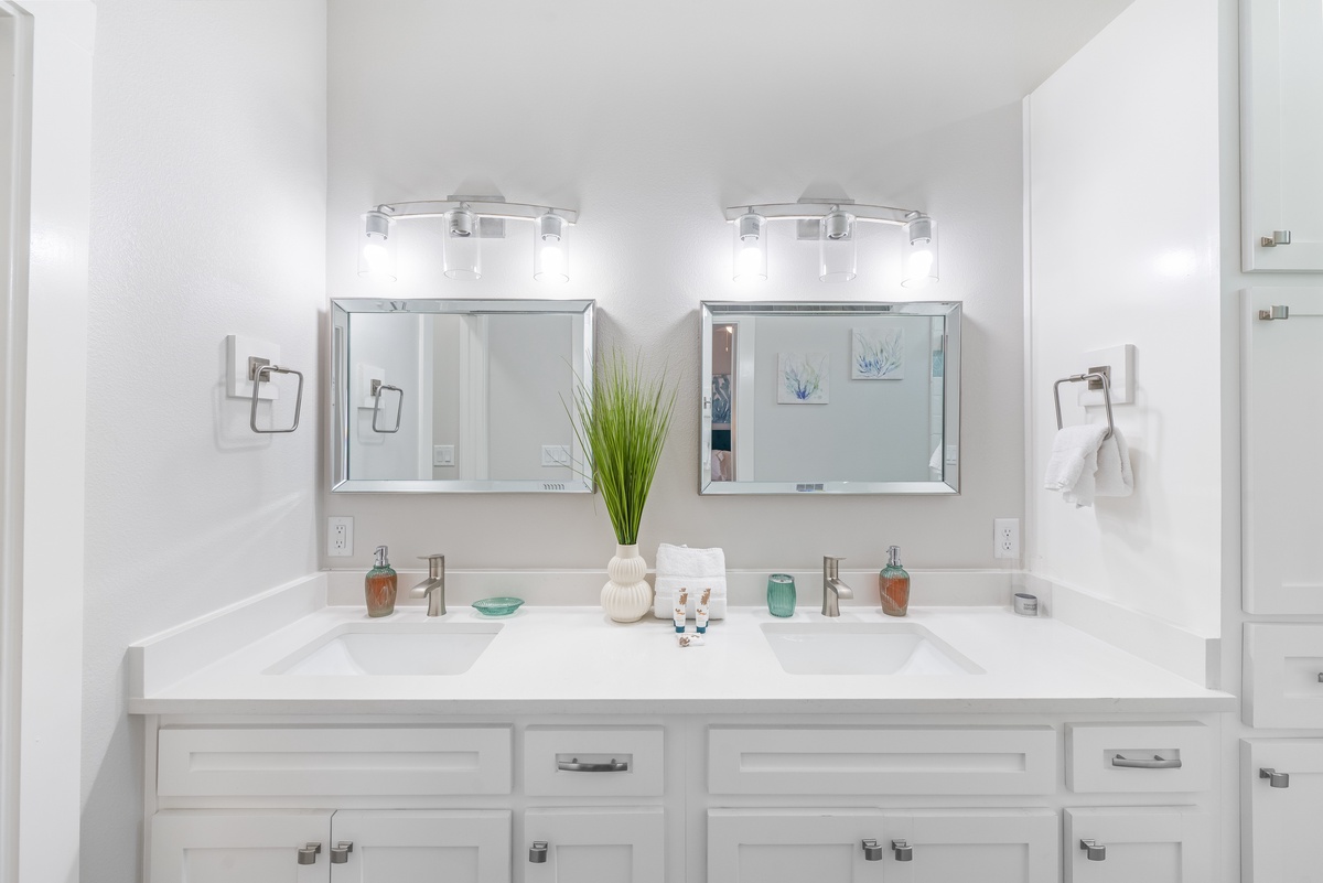 Refresh in your bright, modern dual-sink bathroom with elegant fixtures and thoughtful touches that make your stay feel luxurious.