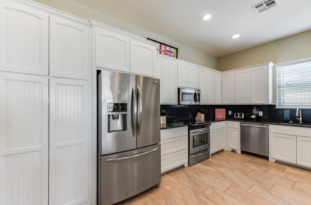 Your fully-equipped kitchen features sleek stainless steel appliances and crisp white cabinets, perfect for preparing your favorite meals.