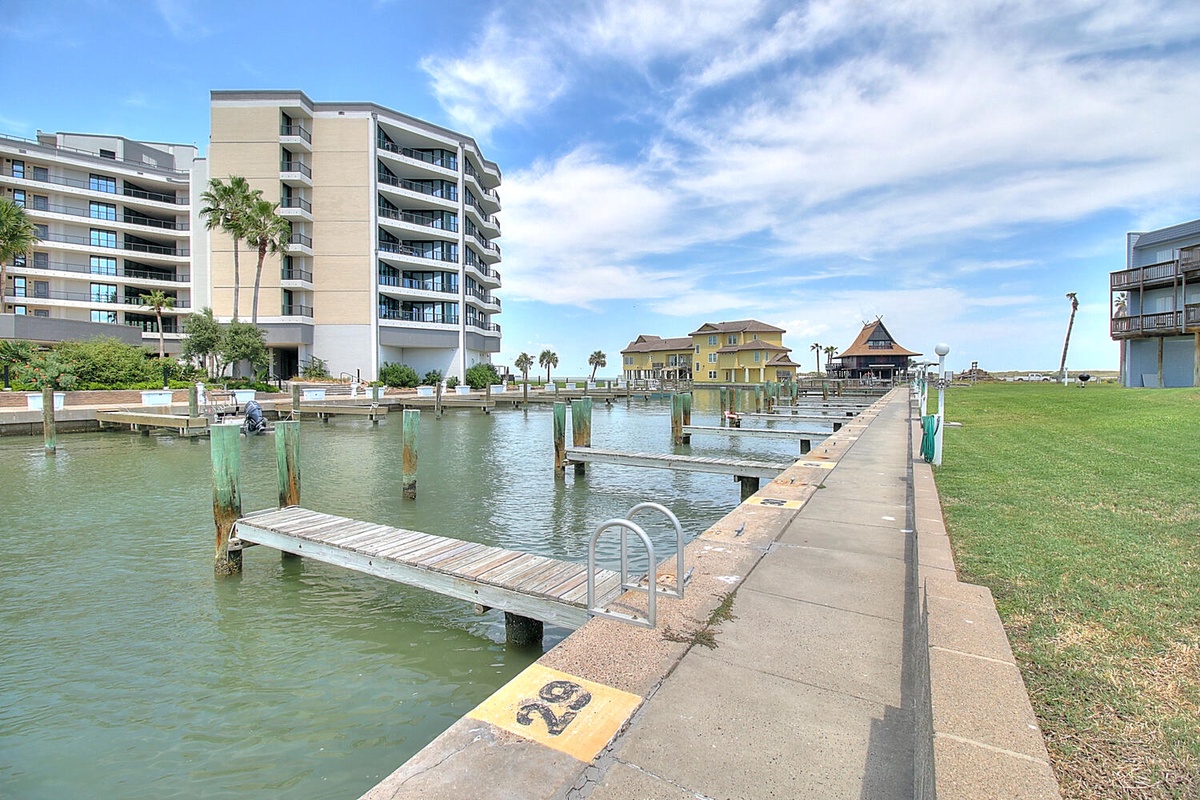 Waterfront property marina with private dock access. Modern multi-story building offers convenient boat slips and easy water access.