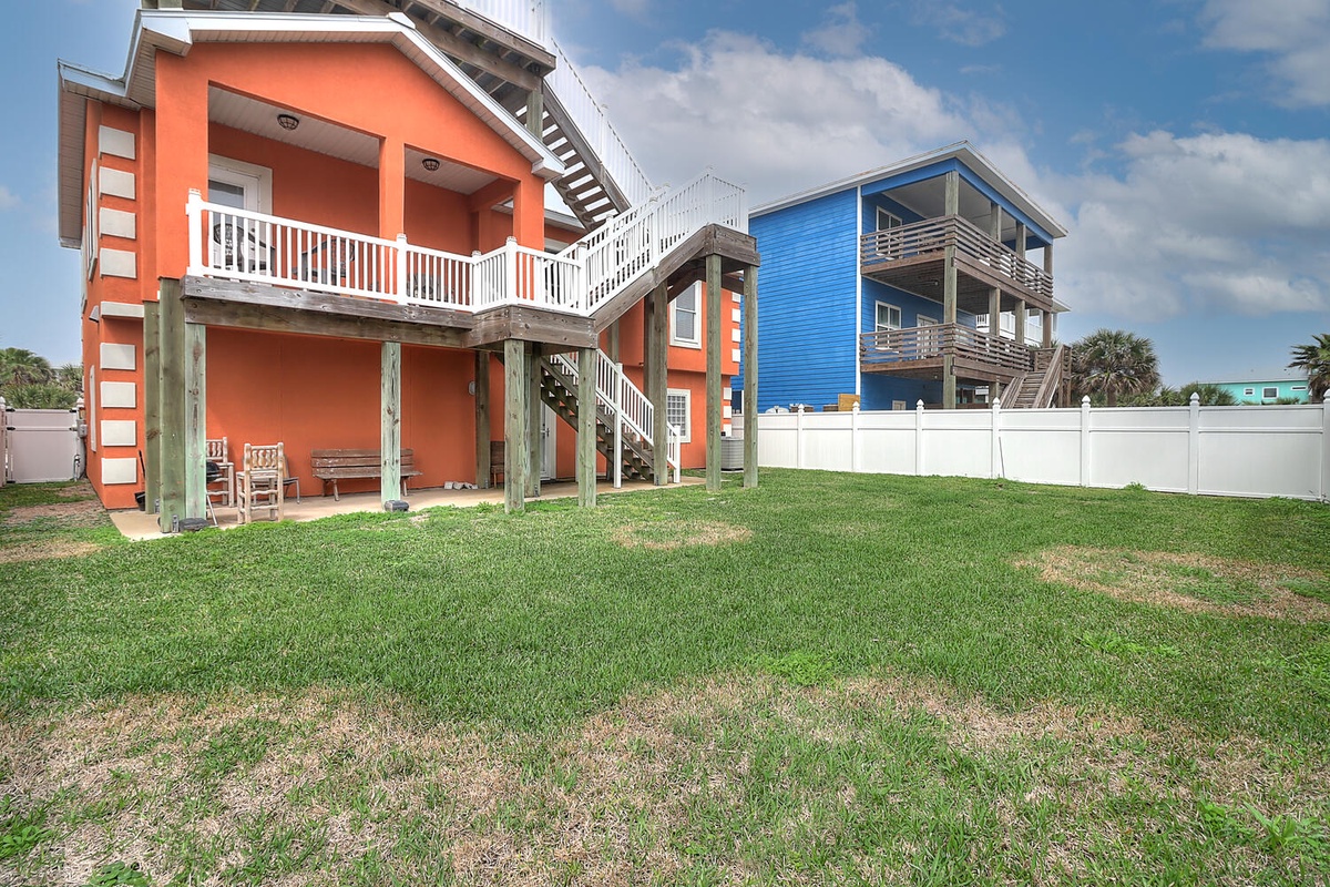 Colorful beachside homes with spacious yards create a vibrant coastal neighborhood setting.