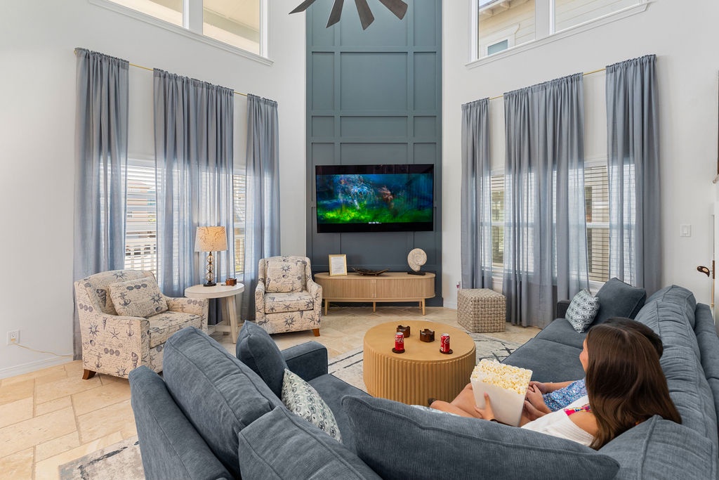 Sink into plush seating and enjoy movie nights in your spacious living room with soaring ceilings and natural light.