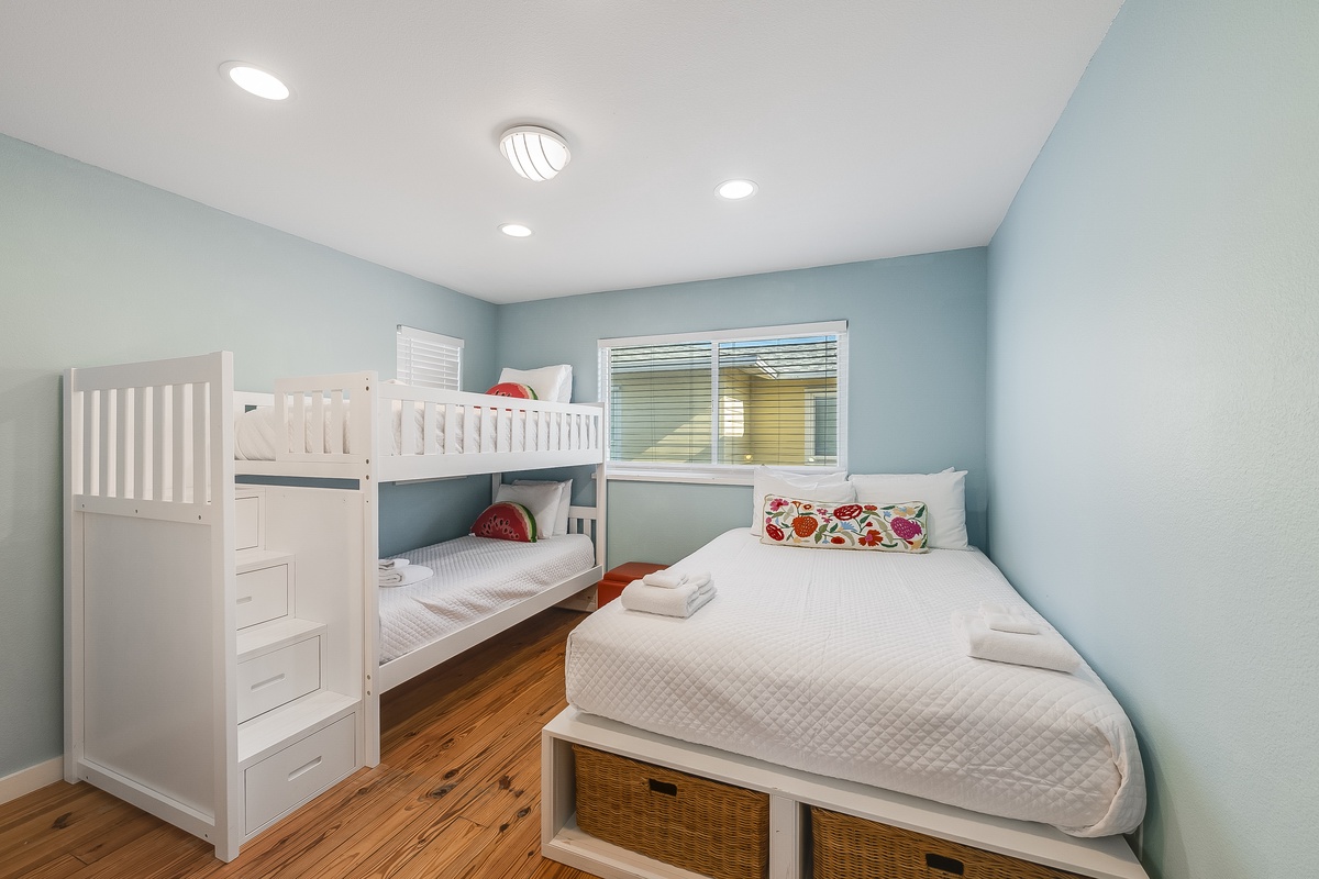 Your family will love this cheerful bedroom with fresh white linens and plenty of space for everyone to rest comfortably after fun-filled days.