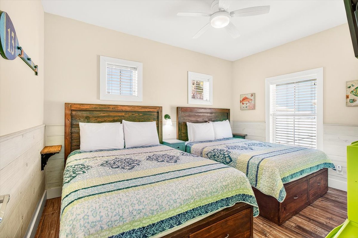 Drift off peacefully in your comfortable twin beds, surrounded by coastal charm and natural light streaming through plantation shutters.