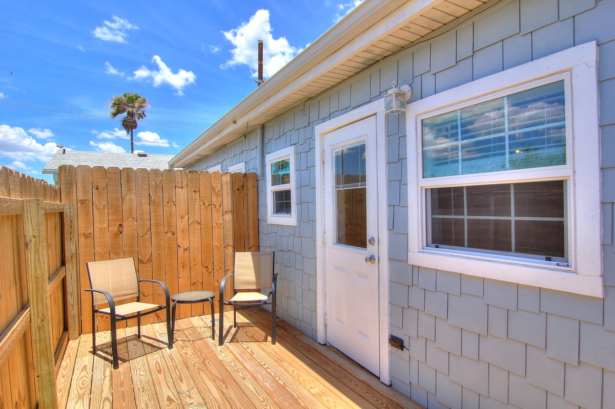 Step out onto your private deck where coastal breezes meet comfortable seating—perfect for morning coffee or evening relaxation under blue skies.