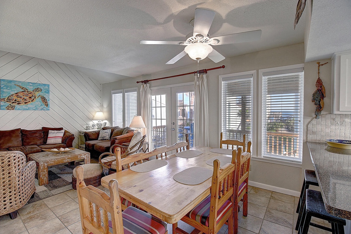 Relax in your bright, coastal-inspired living space where nautical charm meets comfort, complete with ceiling fan and doors opening to your private balcony.