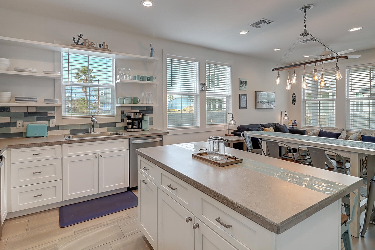Your spacious kitchen island becomes the heart of your beach getaway, where morning coffee and meal prep feel effortless amid coastal charm.