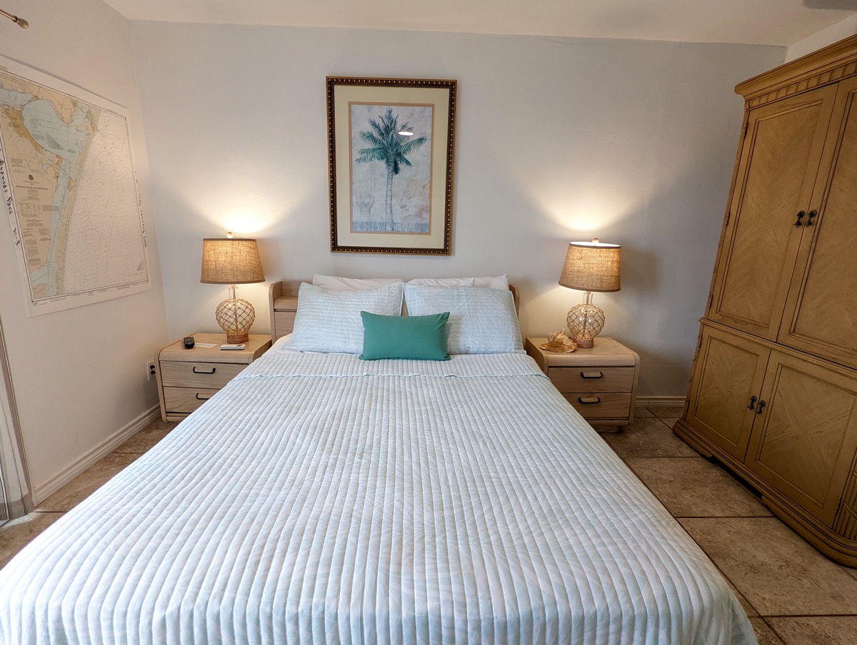 Drift off in your serene bedroom, where coastal art and warm lighting create the perfect retreat after days of exploration.