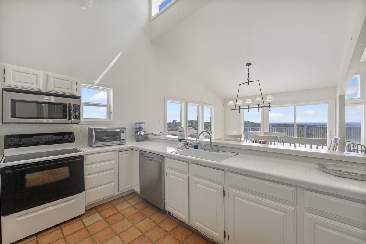 Your bright, fully-equipped kitchen features modern appliances and stunning panoramic views that make cooking a joy.
