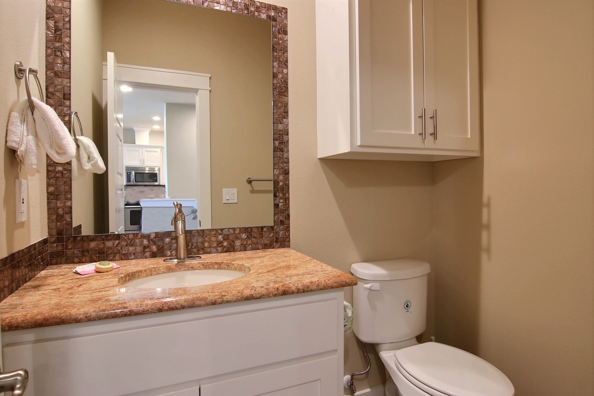 Your private bathroom features elegant granite counters and mosaic tile accents, with fresh towels and convenient storage for your comfort.