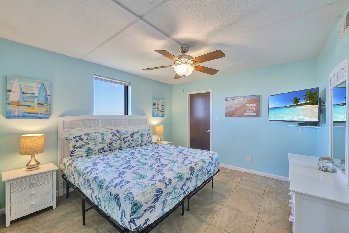 Drift off to tropical dreams in your soothing bedroom, where ocean-inspired décor and gentle ceiling fan breezes create your perfect coastal retreat.