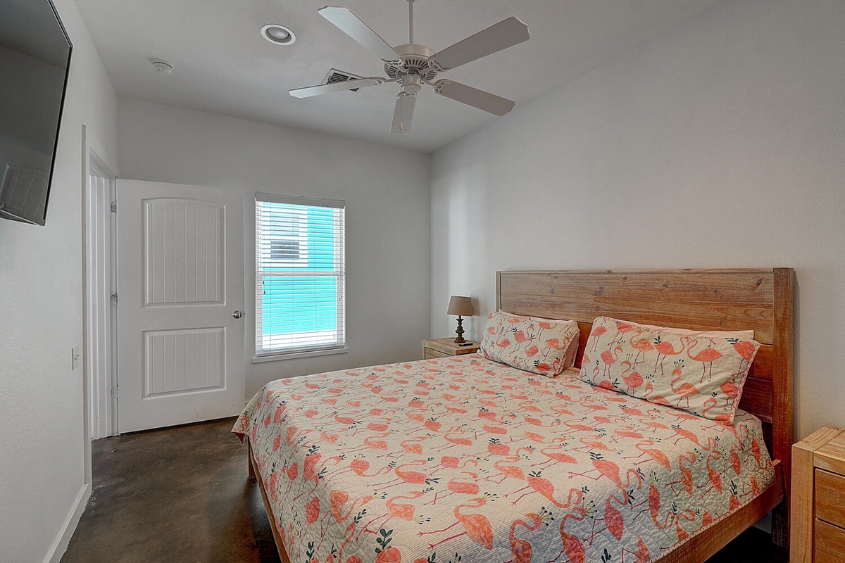 Drift off to sleep surrounded by charming flamingo-themed bedding in your bright, airy bedroom with gentle ceiling fan breezes.
