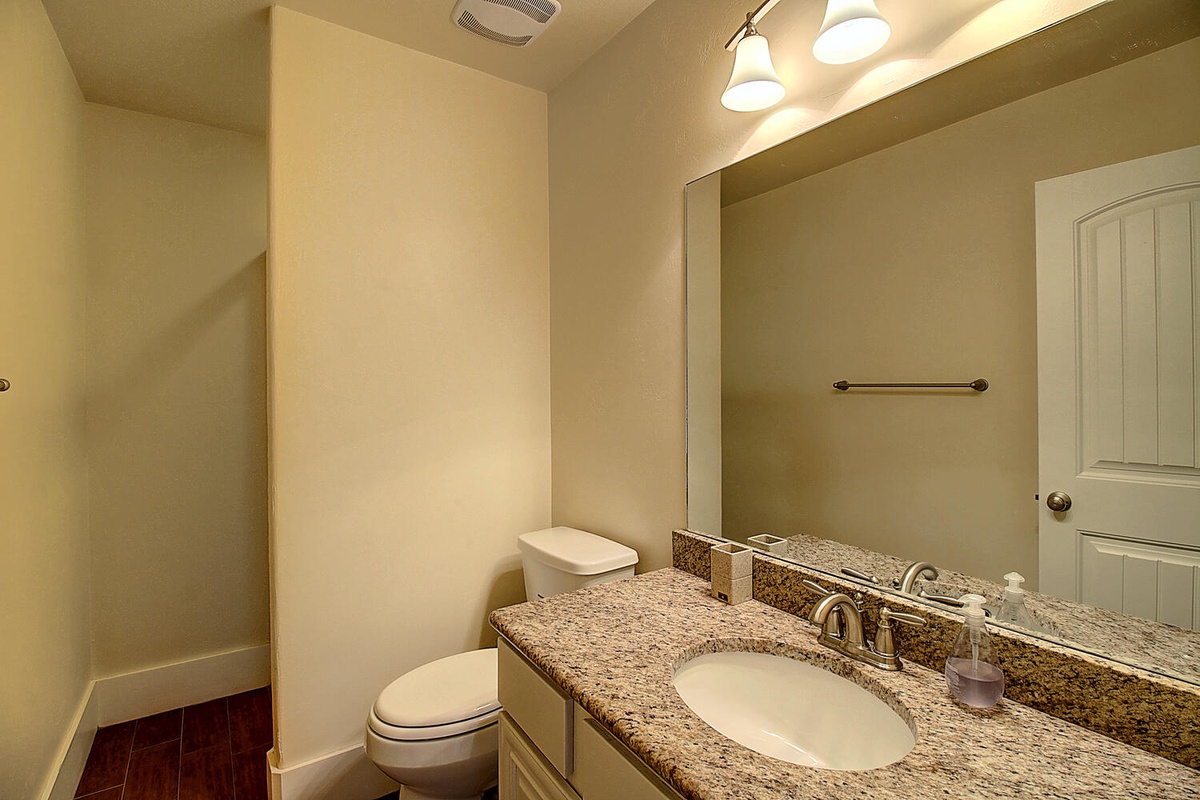 Your private bathroom features granite countertops, warm vanity lighting, and thoughtful touches that make your daily routine feel luxurious and comfortable.