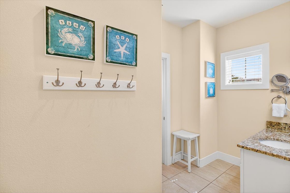 Coastal charm meets convenience in your private bathroom, complete with beach-themed artwork and thoughtful touches for a relaxing seaside getaway.