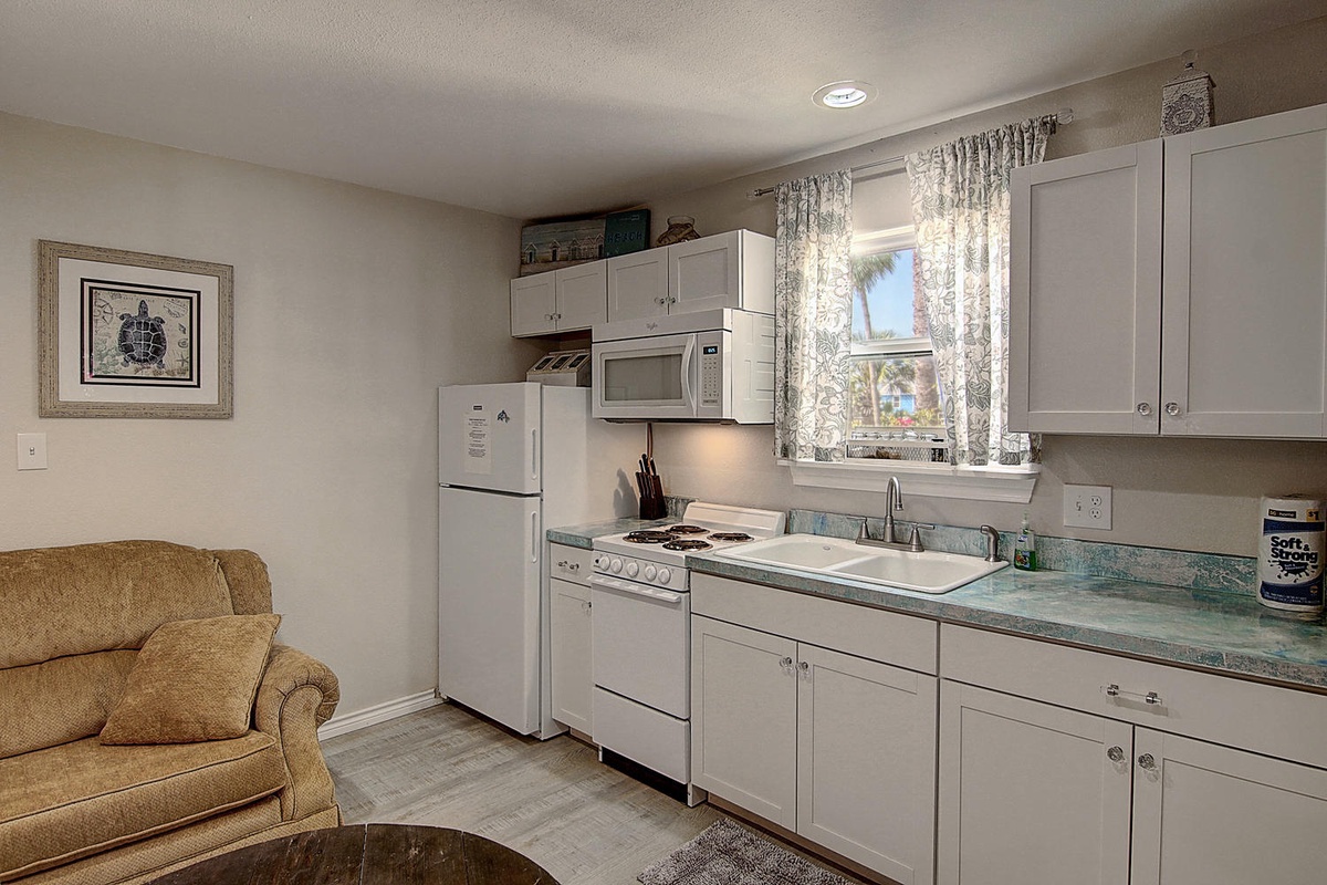 Your fully equipped kitchen features modern appliances and a cozy seating area, perfect for preparing meals and relaxing during your stay.