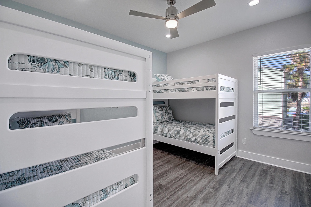 Your family will love this bright bunk room where kids can create memories together, complete with comfy bedding and plenty of natural light.