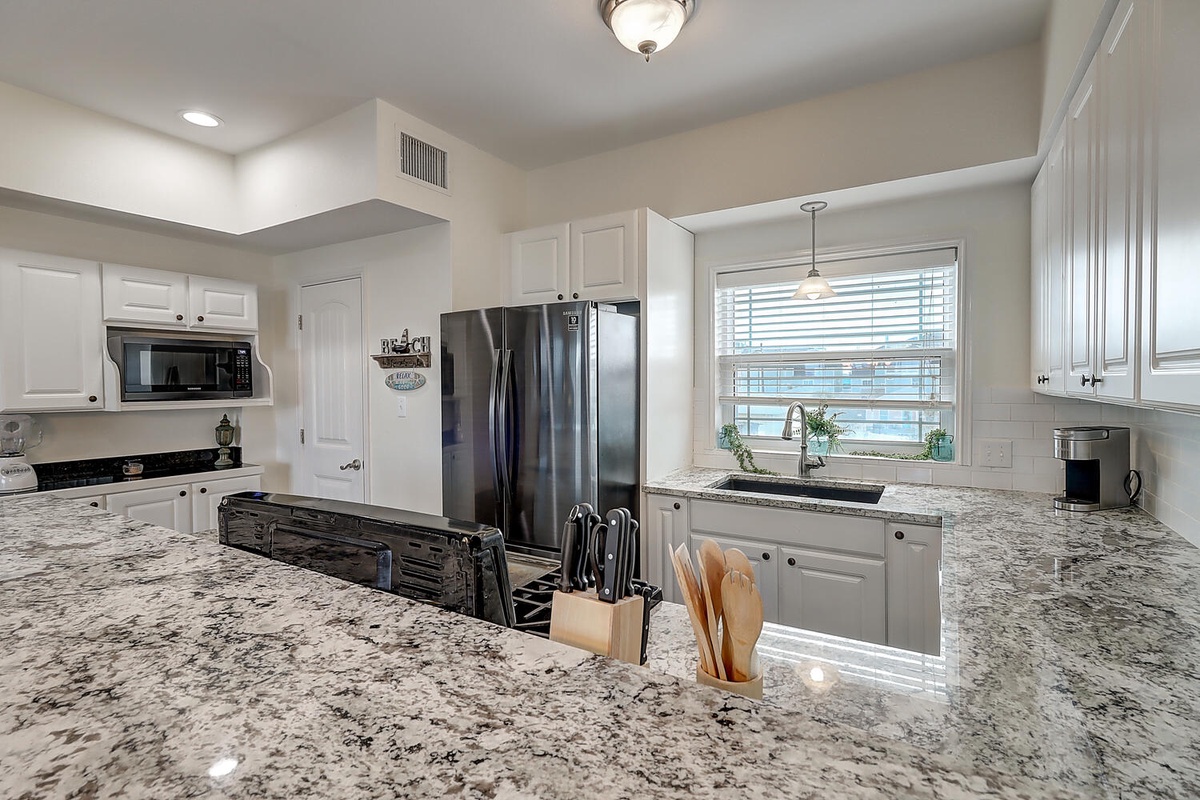 Your spacious kitchen awaits with granite countertops, stainless steel appliances, and everything needed to create memorable meals during your stay.