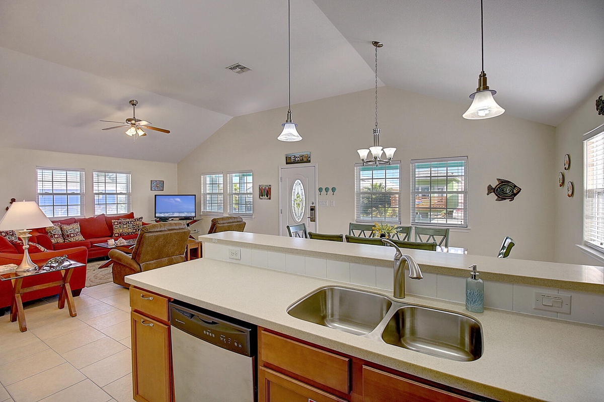 Your open-concept kitchen flows seamlessly into the bright living area, where you can cook while chatting with loved ones.