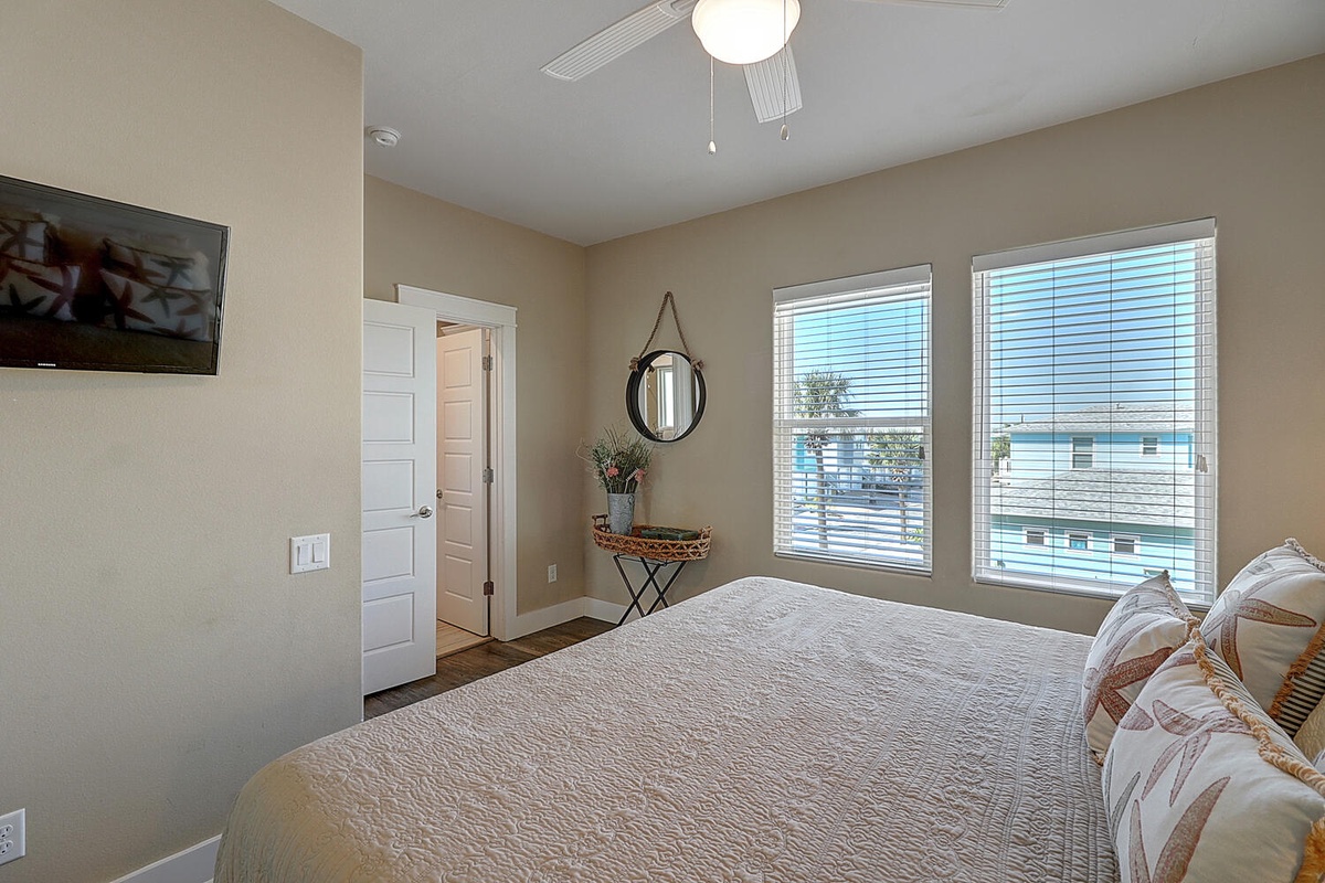 Unwind in your serene bedroom where soft linens meet natural light from two large windows. Your peaceful retreat awaits.