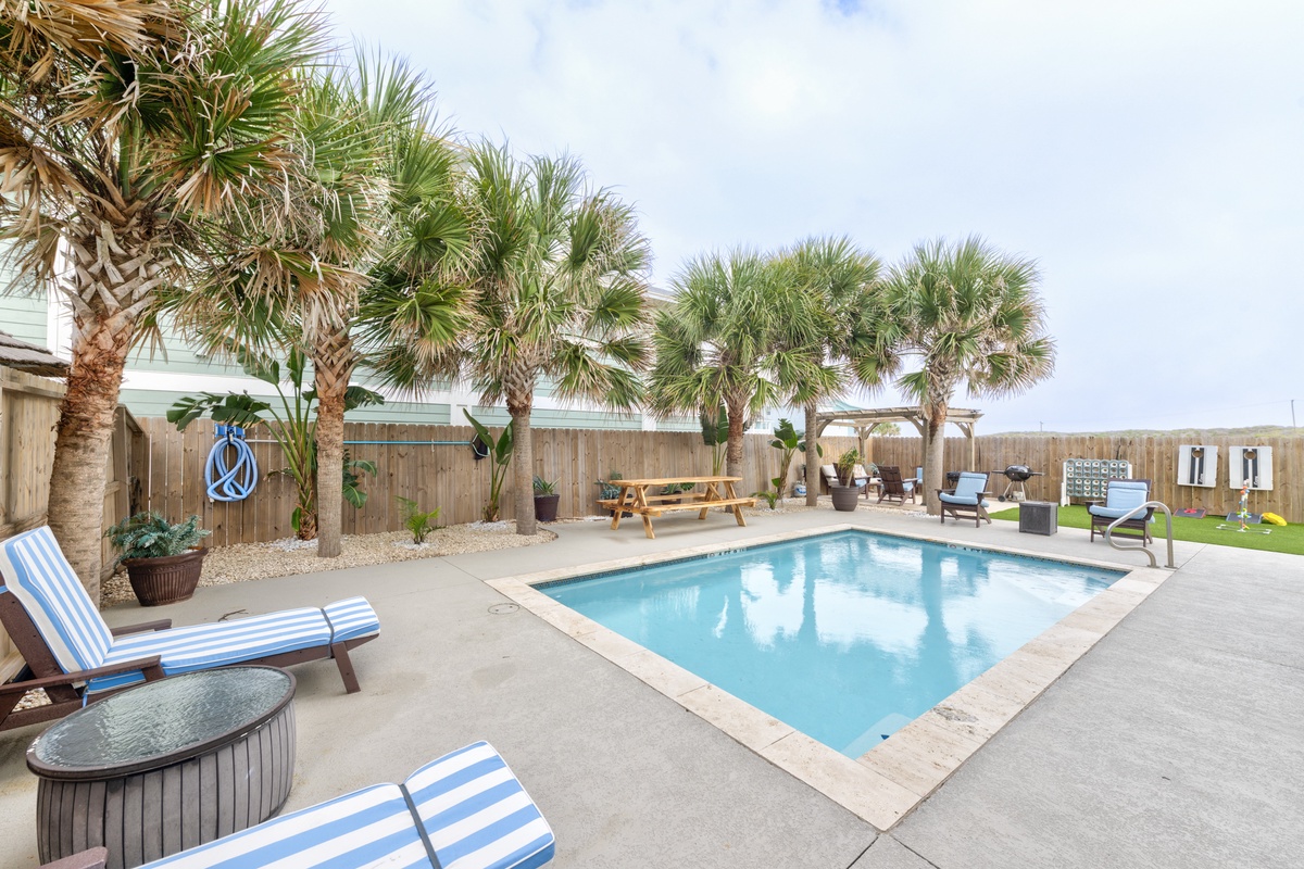 Dive into your private pool oasis, surrounded by tropical palms and comfortable loungers where endless summer days await.