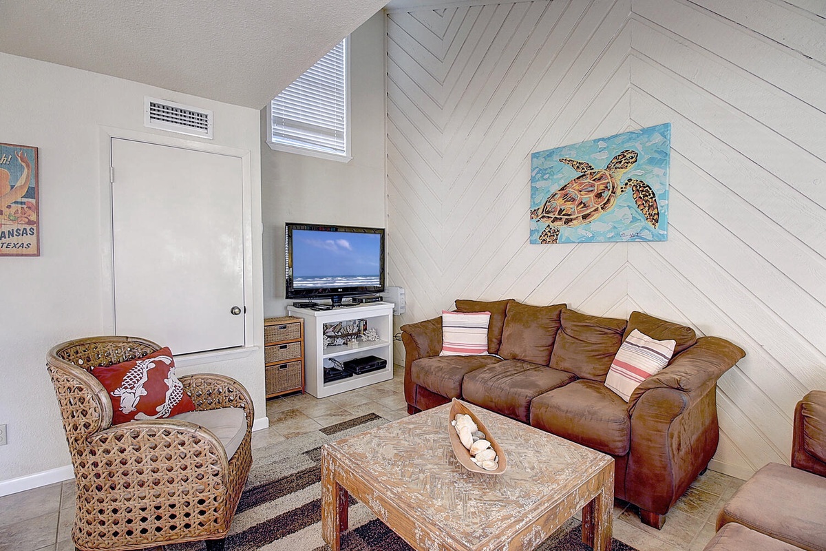 Sink into plush leather seating while sea turtle artwork and coastal touches create your perfect beach house retreat.