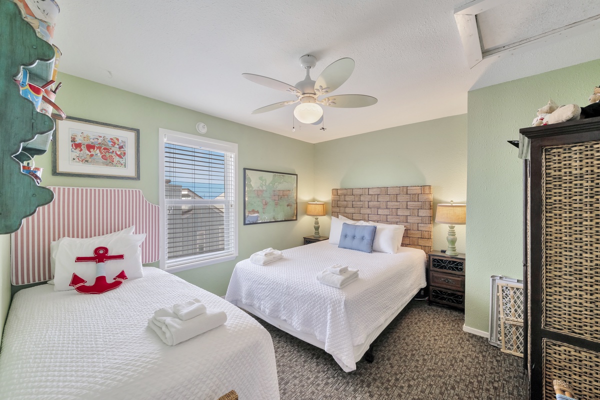 Rest in coastal charm with crisp linens, nautical touches, and gentle breezes from your ceiling fan creating the perfect beach getaway sanctuary.