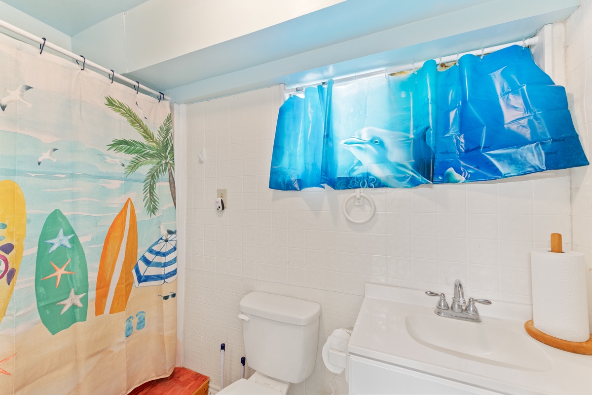 Dive into your beach-themed bathroom with playful surf curtains and ocean vibes that make every moment feel like a coastal getaway.