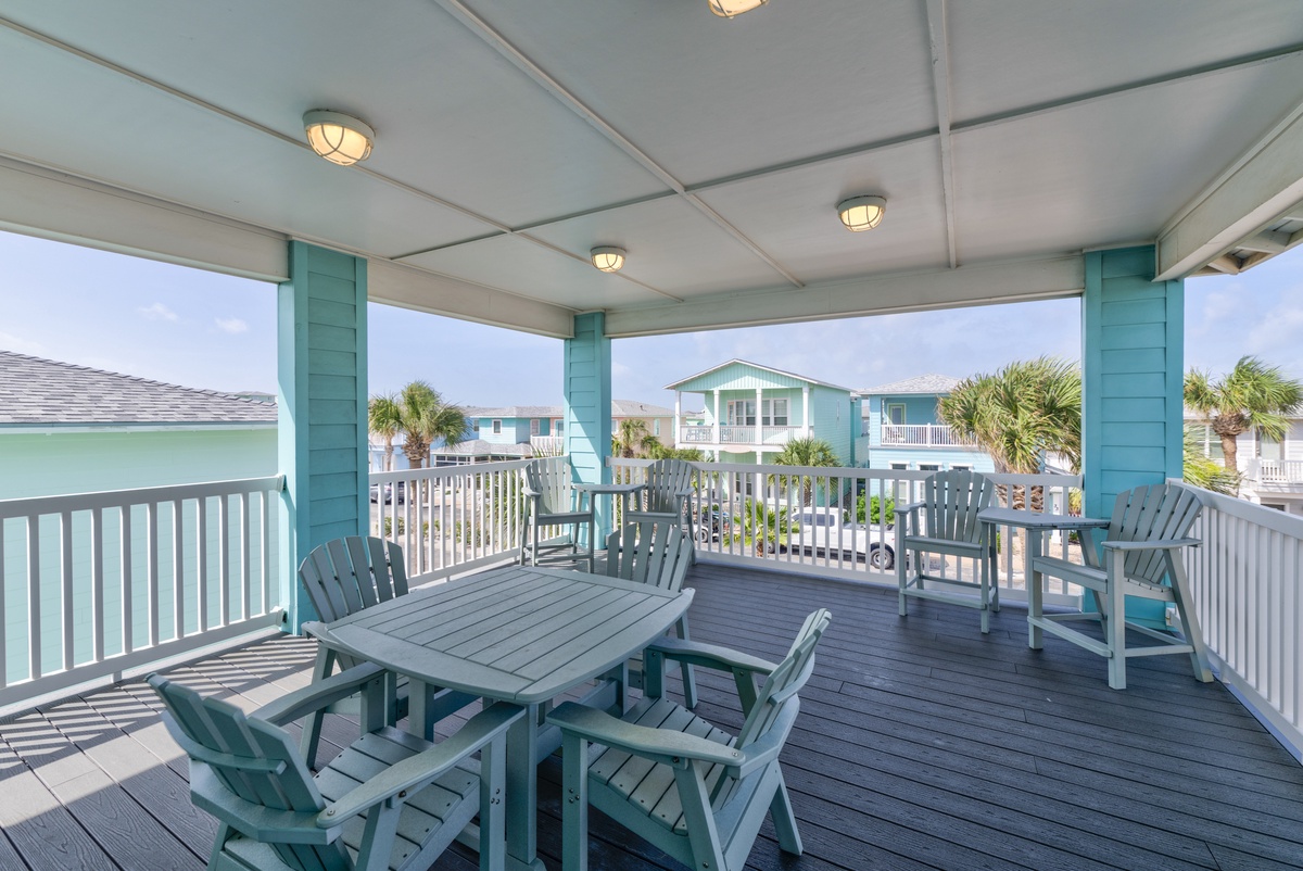 Unwind on your private covered deck with coastal-style seating where gentle breezes and peaceful neighborhood views create your perfect retreat.
