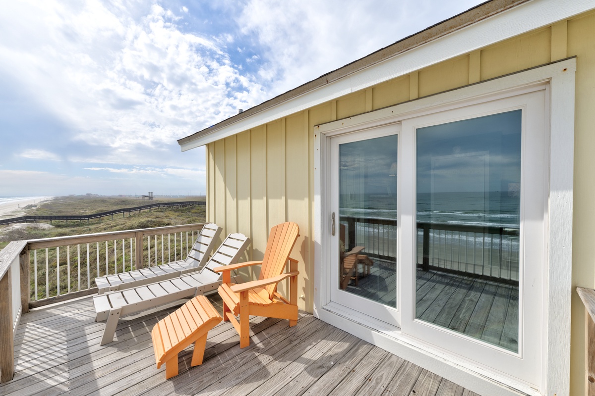 Unwind on your private deck with stunning ocean views. The bright orange Adirondack chair awaits your morning coffee or sunset contemplation.