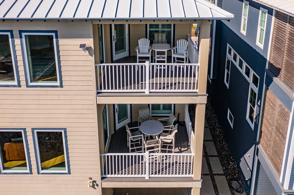 Multi-level vacation rental building featuring private balconies with outdoor seating for relaxing and dining.