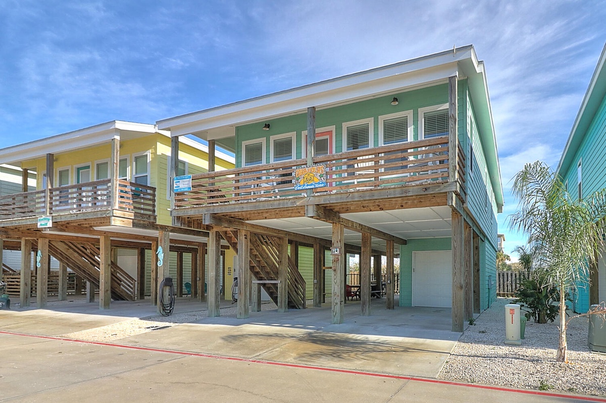 Colorful beachside property with elevated design and covered parking for a relaxing coastal getaway.