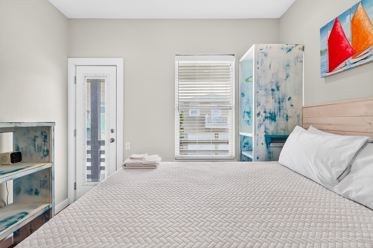Bright and welcoming, this coastal bedroom offers a comfortable retreat with natural light and beach-inspired décor.