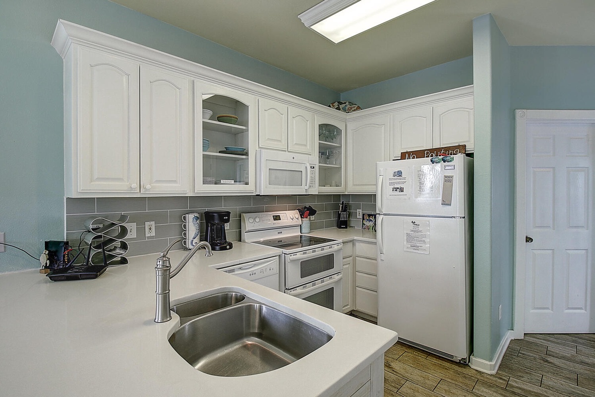 Your bright, fully-equipped kitchen awaits with everything you need to create home-cooked meals during your stay.