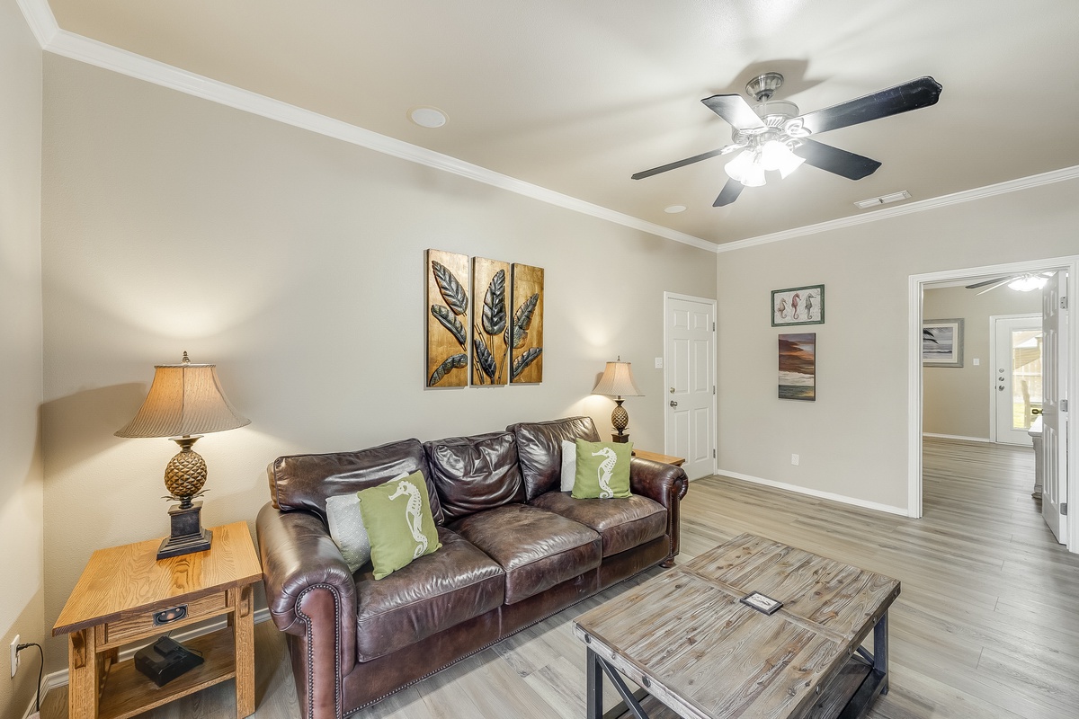 Relax in your stylish living room with rich leather seating and warm ambient lighting for cozy evenings.