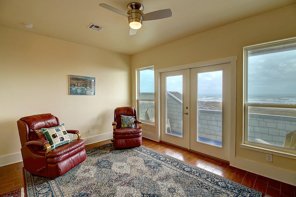 Unwind in your private retreat with leather recliners and stunning ocean views through floor-to-ceiling windows.